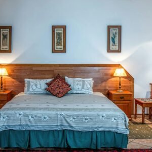 Stylish bedroom featuring wooden furniture and soft lighting for a warm ambiance.