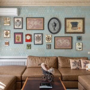 Cozy vintage-style living room with a brown sofa and an art-filled wall, creating a warm, elegant ambiance.
