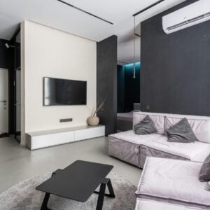 Spacious and stylish modern living room with sleek furnishings and minimalistic decor.